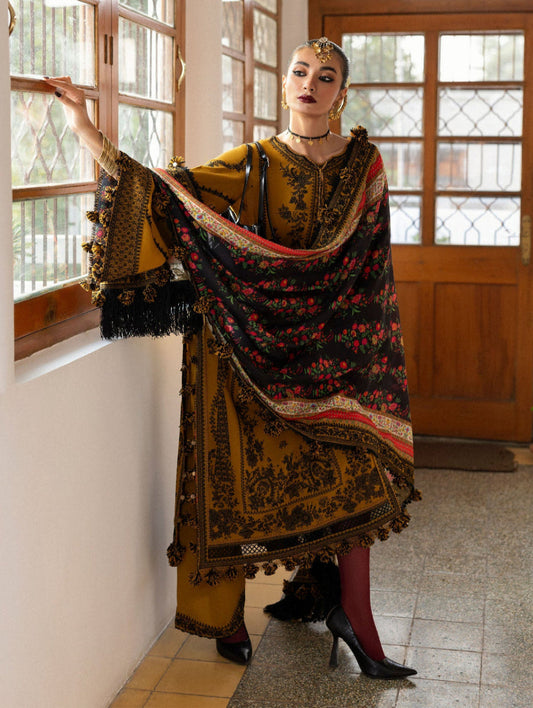 Woman in traditional outfit with a floral shawl in a room with wooden doors and windows.