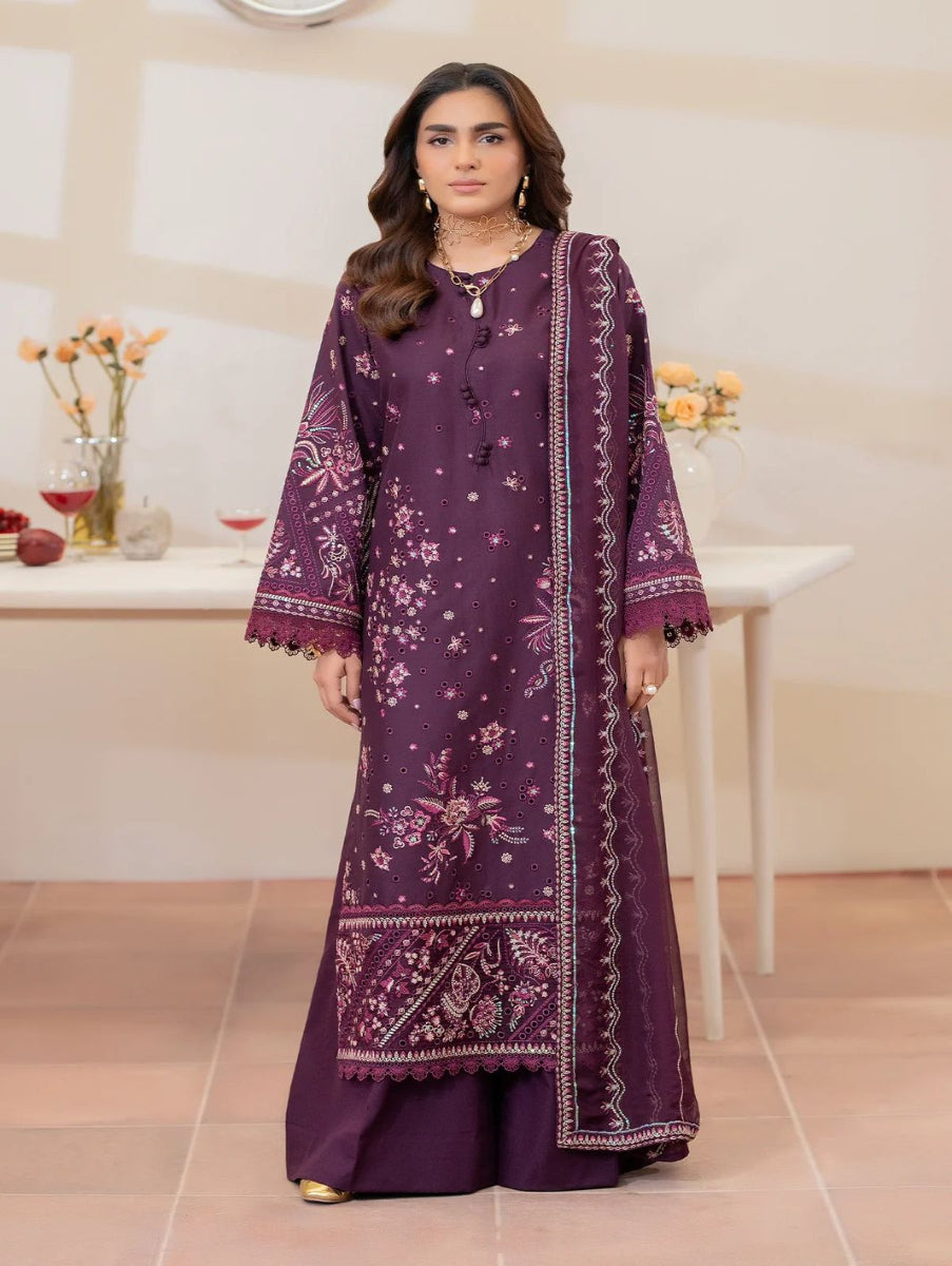 Woman wearing a purple embroidered traditional outfit in an indoor setting.
